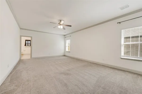 an empty room with windows and closet