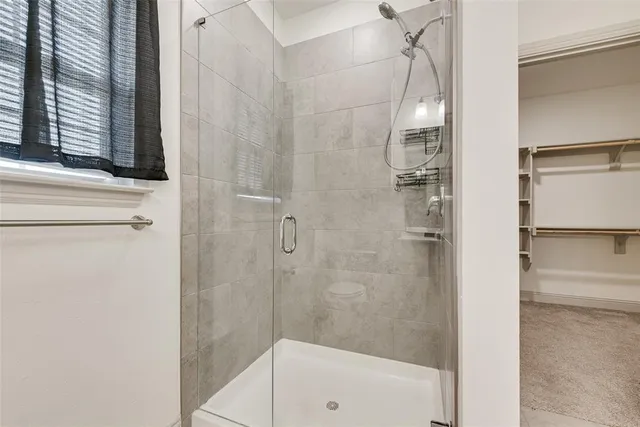 a bathroom with a glass shower door