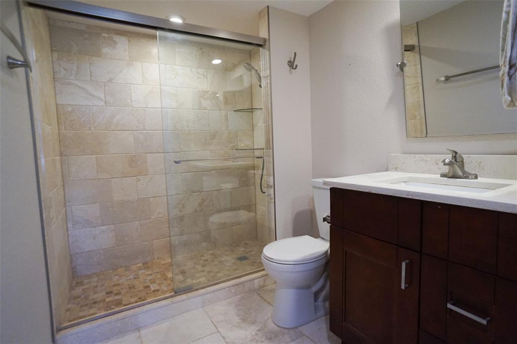 400 Island Way, Unit 308 Clearwater, FL 33767 - Photo 11 of 32 a bathroom with a sink and a mirror