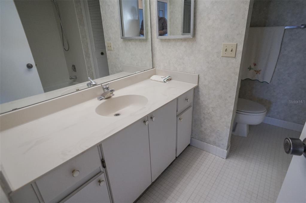 400 Island Way, Unit 308 Clearwater, FL 33767 - Photo 19 of 32 a bathroom with a sink and a toilet