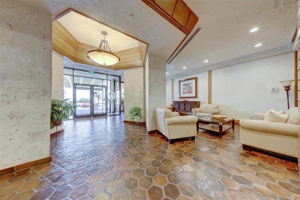400 Island Way, Unit 308 Clearwater, FL 33767 - Photo 25 of 32 a living room with furniture and wooden floor