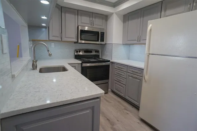 a kitchen with a sink a stove and refrigerator