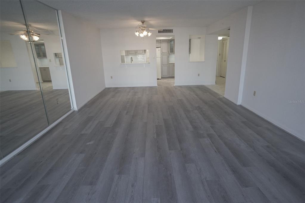 400 Island Way, Unit 308 Clearwater, FL 33767 - Photo 8 of 32 an empty room with wooden floor and entrance