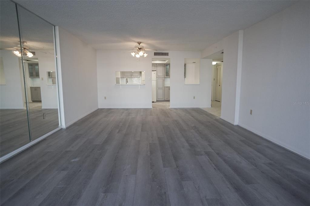 400 Island Way, Unit 308 Clearwater, FL 33767 - Photo 9 of 32 wooden floor in an empty room with a window