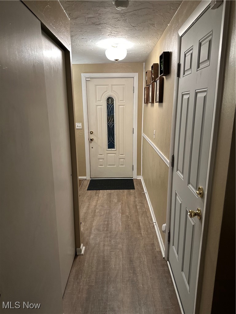 46580 Middle Ridge Road Amherst, OH 44001 - Photo 7 of 38 Entryway featuring a textured ceiling and wood finished floors