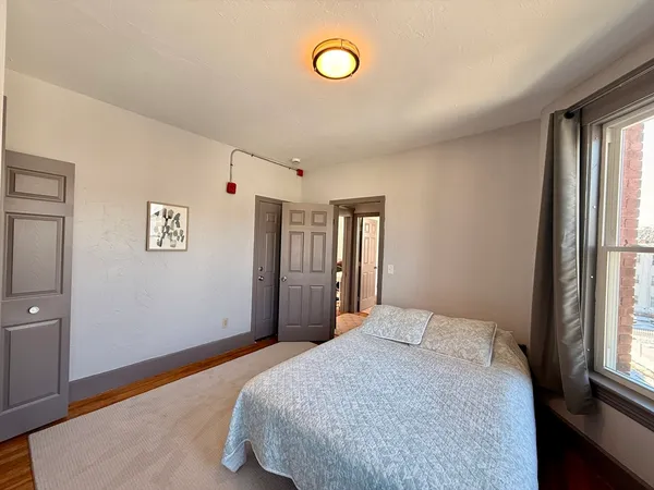 a bedroom with a bed and a window