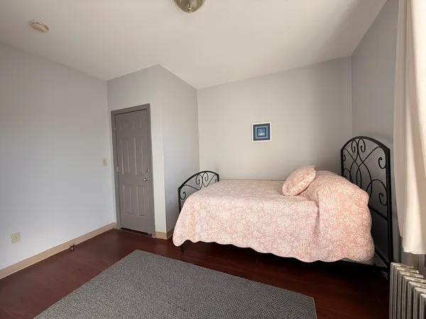 a bedroom with a bed and a night stand