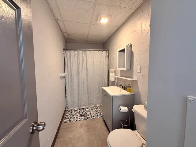 a white toilet sitting next to a bathroom sink