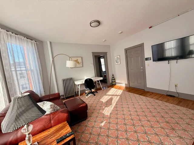 a bedroom with furniture and a flat screen tv