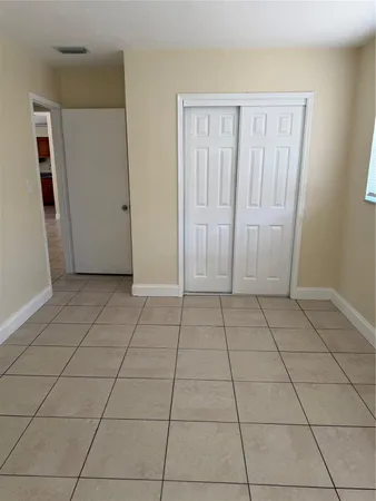 a view of a livingroom with an empty space and a window