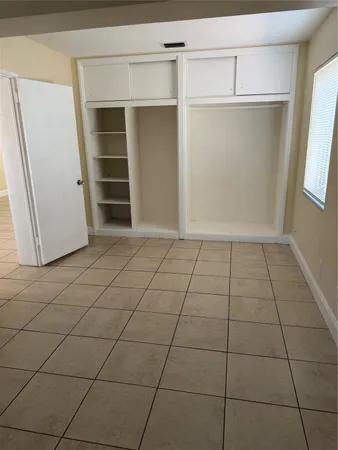 a view of a closet area with an empty room