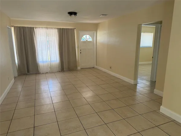 a view of a livingroom with an empty space and a window