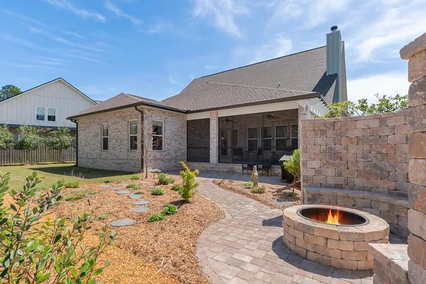 a living room with furniture a fireplace and a table