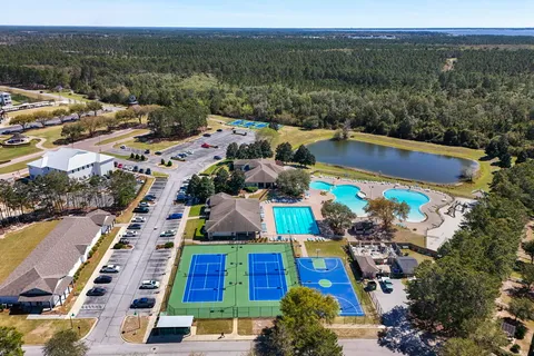 a kitchen with granite countertop white cabinets and stainless steel appliances