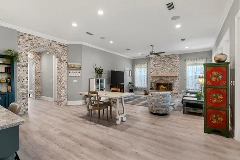 a view of a swimming pool with lawn chairs and a big yard