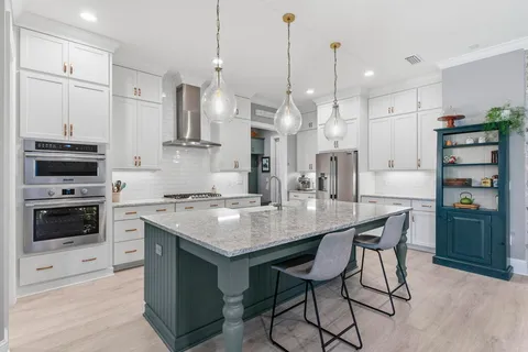 a view of swimming pool with outdoor seating and trees in the background