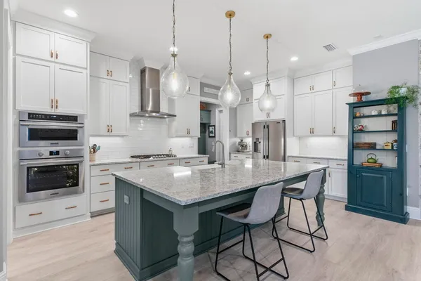 a view of swimming pool with outdoor seating and trees in the background