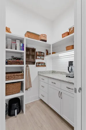 a view of outdoor space with seating area and trees in the background