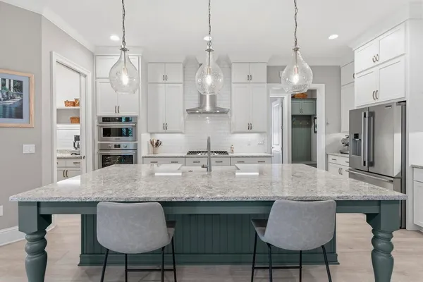 a en suite bathroom with a granite countertop sink and a mirror