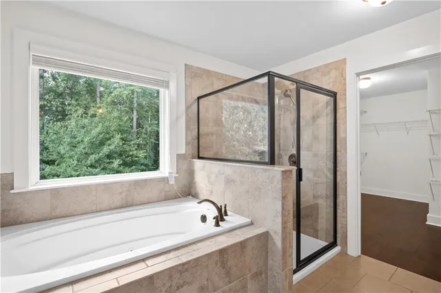 a bathroom with a bathtub and a shower