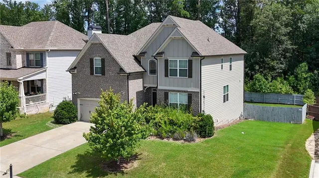a aerial view of a house with a yard and plants