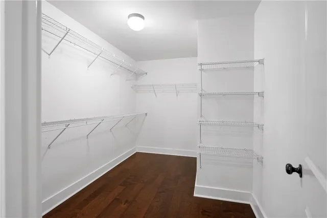 a view of walk in closet with empty racks