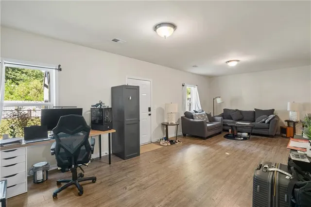 a livingroom with workspace chair and a window