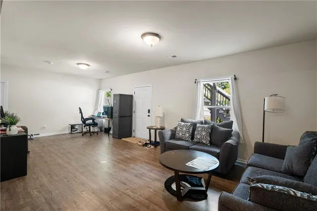 a living room with furniture and a gym cycle