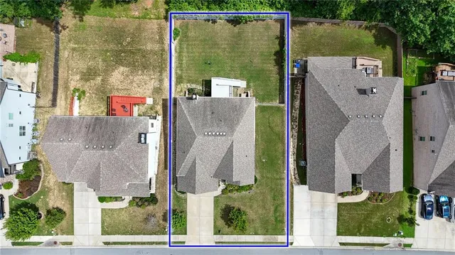 an aerial view of a houses with yard