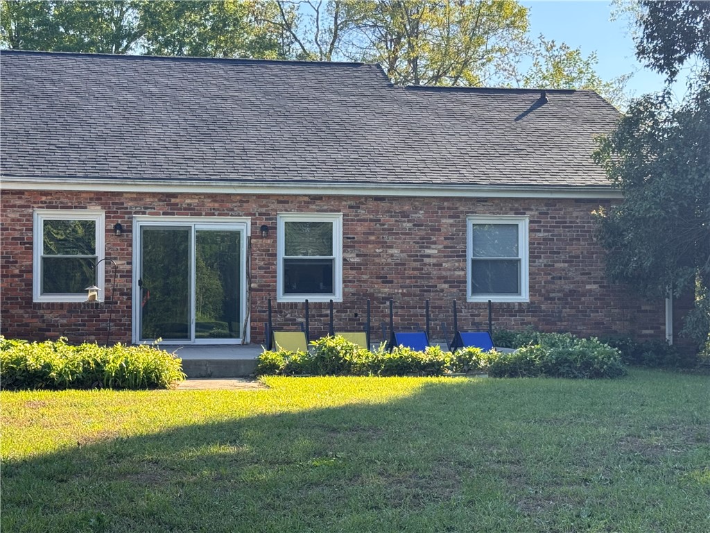 2211 East River Street Anderson, SC 29621 - Photo 4 of 40 This outdoor space features a brick exterior and lush green lawn, perfect for relaxation and entertaining.