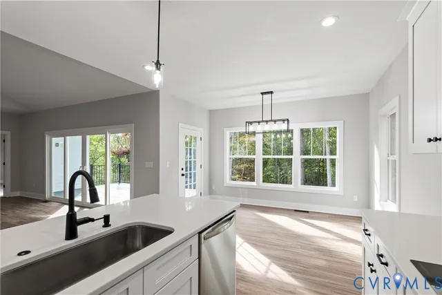 a view of a kitchen counter space a sink and windows