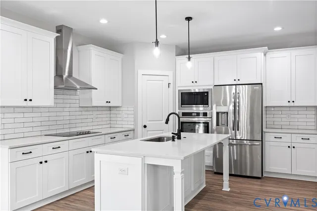 a kitchen with stainless steel appliances a refrigerator sink and microwave