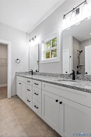 a bathroom with double sink and a mirror