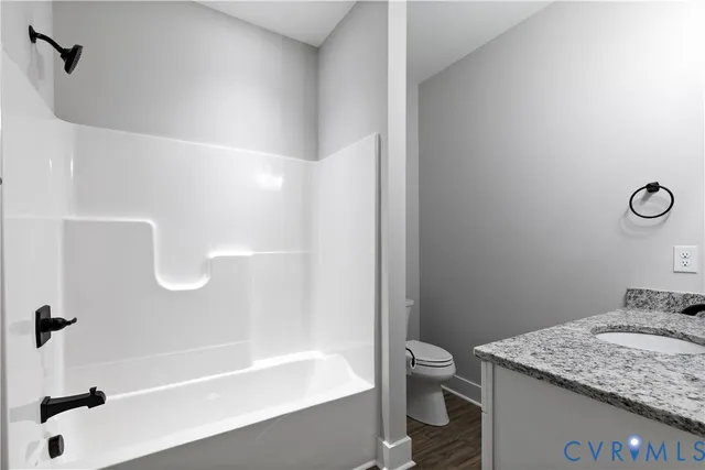 an empty room with a window and a ceiling fan