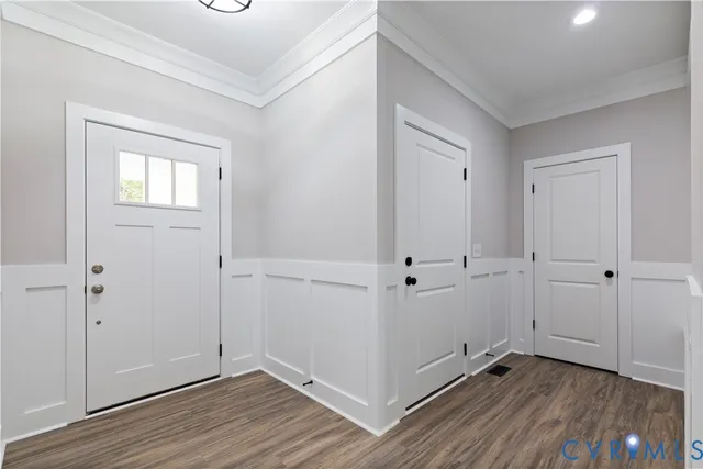 a view of an empty room with wooden floor