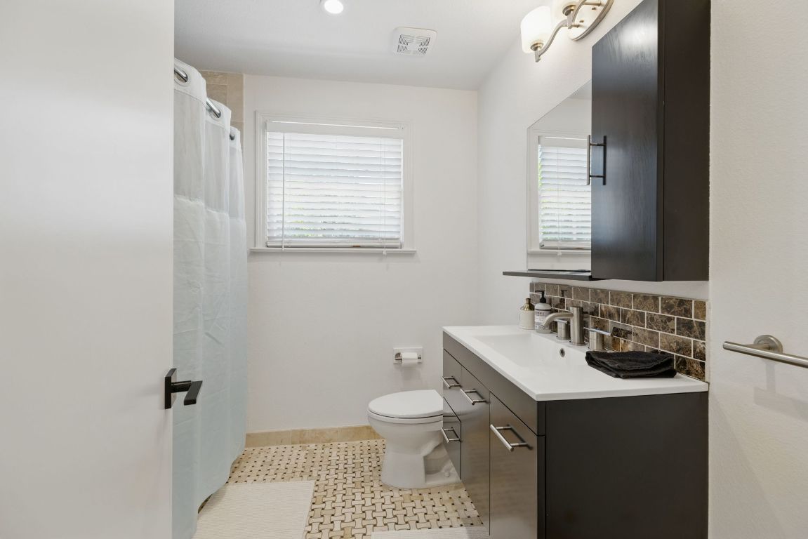 6010 Nasco Drive Austin, TX 78757 - Photo 14 of 34 a bathroom with a sink toilet and mirror