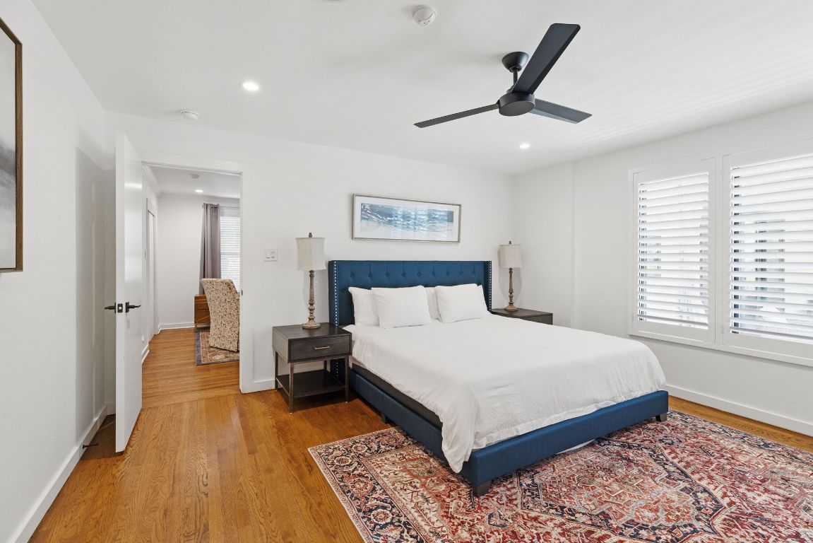 6010 Nasco Drive Austin, TX 78757 - Photo 16 of 34 a bedroom with a large bed and a chandelier