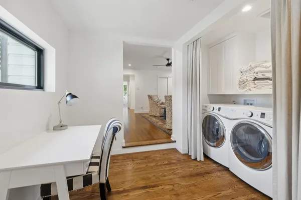 a view of a dining room with furniture and a chandelier