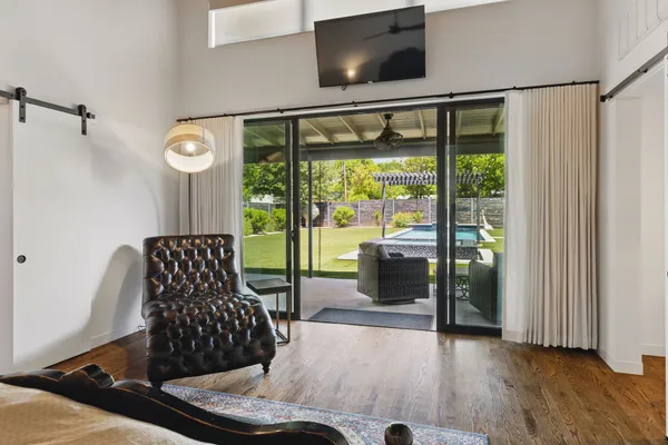 a living room with furniture and a floor to ceiling window