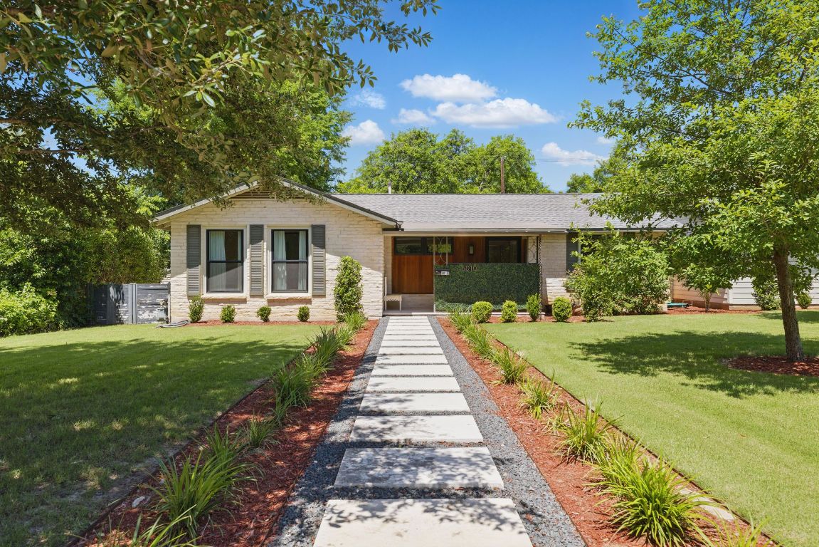 6010 Nasco Drive Austin, TX 78757 - Photo 2 of 34 a front view of a house with yard and green space