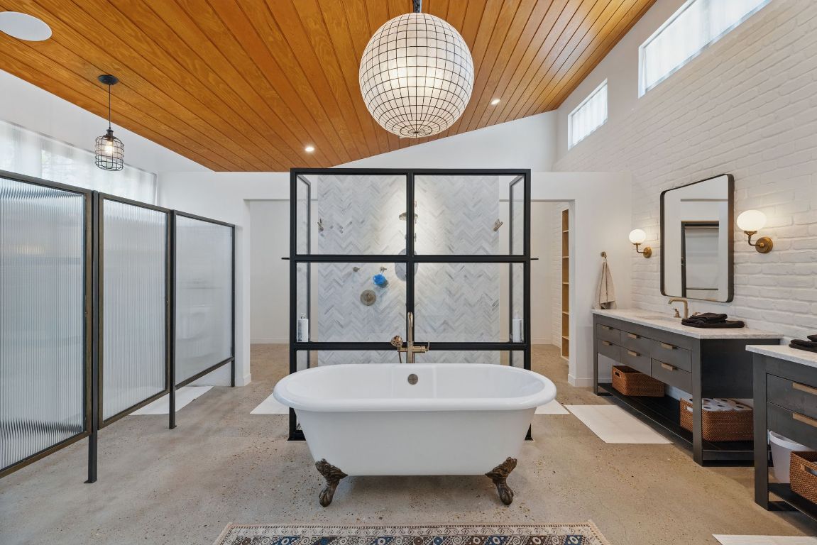 6010 Nasco Drive Austin, TX 78757 - Photo 21 of 34 a bathroom with a sink a mirror and a shower