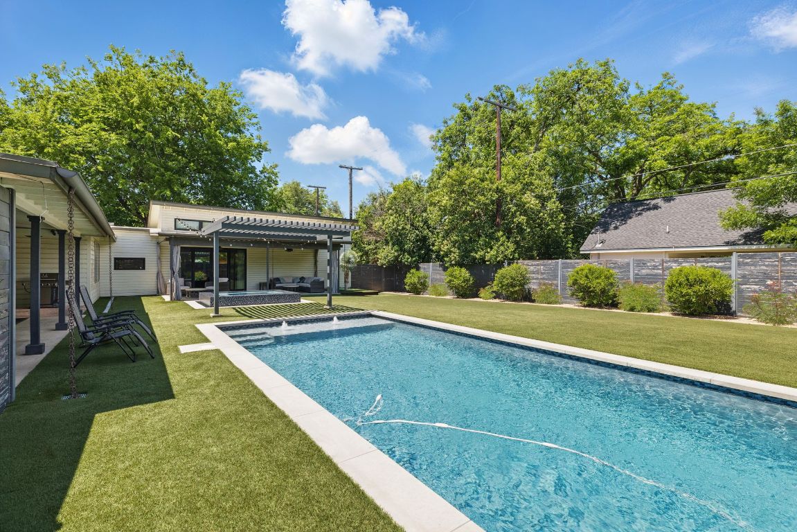 6010 Nasco Drive Austin, TX 78757 - Photo 25 of 34 a view of a house with swimming pool and a yard
