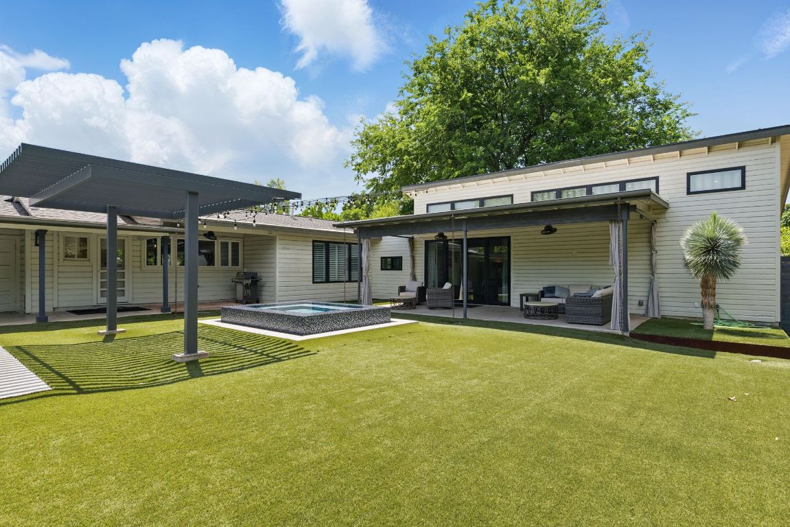 6010 Nasco Drive Austin, TX 78757 - Photo 28 of 34 a view of a house with swimming pool and a yard