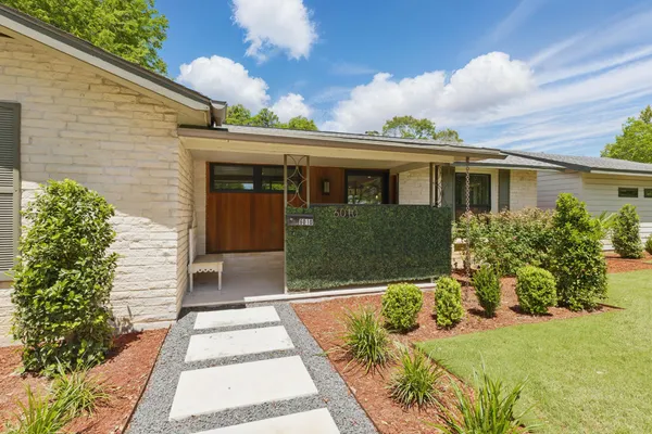 a front view of a house with garden