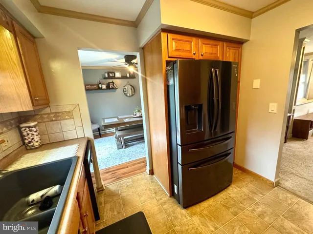 a kitchen with stainless steel appliances a refrigerator and cabinets