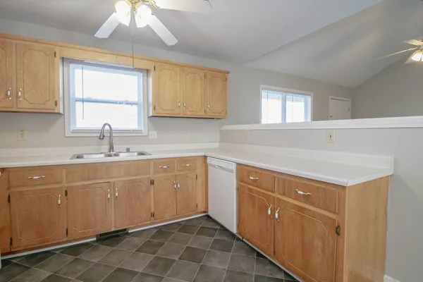 a kitchen with a sink cabinets and window