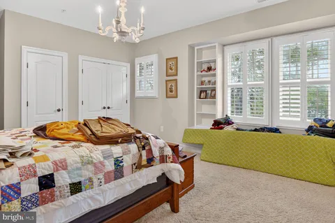 a bedroom with a bed and a chandelier