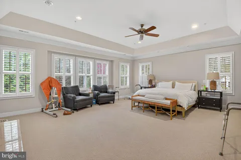 a spacious bedroom with a bed and a couch