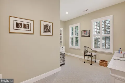 a view of a livingroom with workspace and a couch
