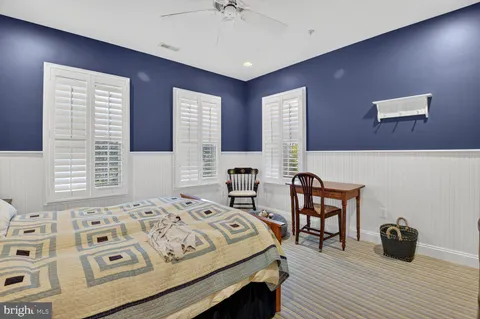 a bedroom with a bed and a table with rug